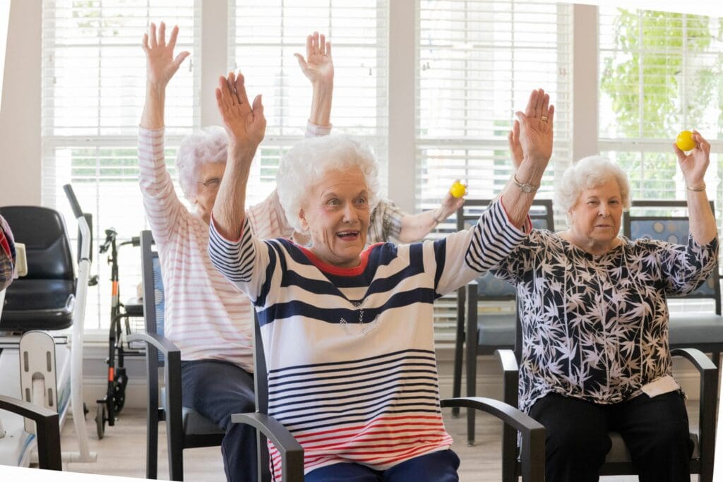 Seniors exercising while sitting in chairs